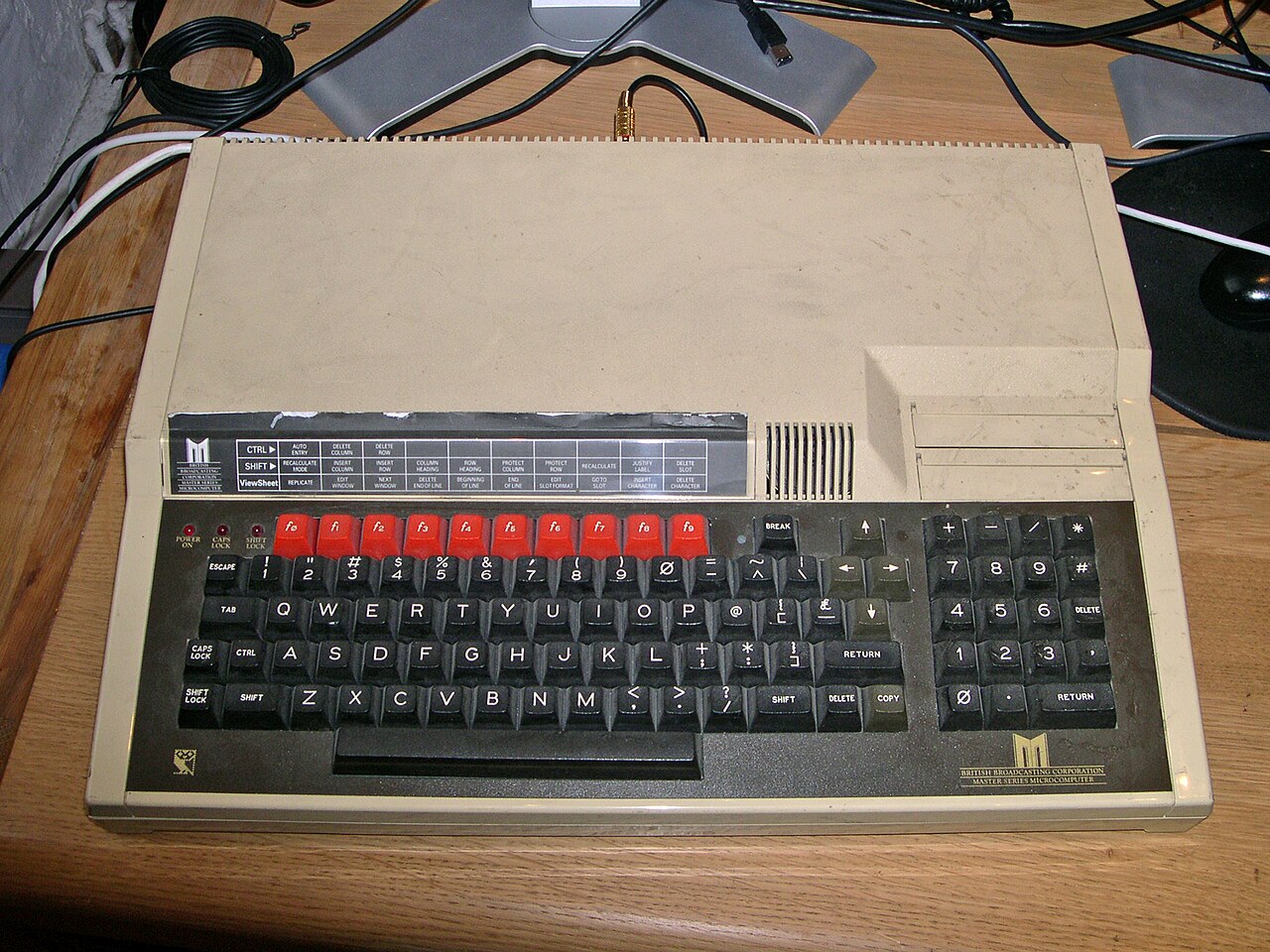 An Acorn BBC Master computer, a wider cream machine with a numeric keypad on the right