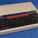 A cream-coloured Acorn BBC Micro Model B computer with its black keyboard and red function keys