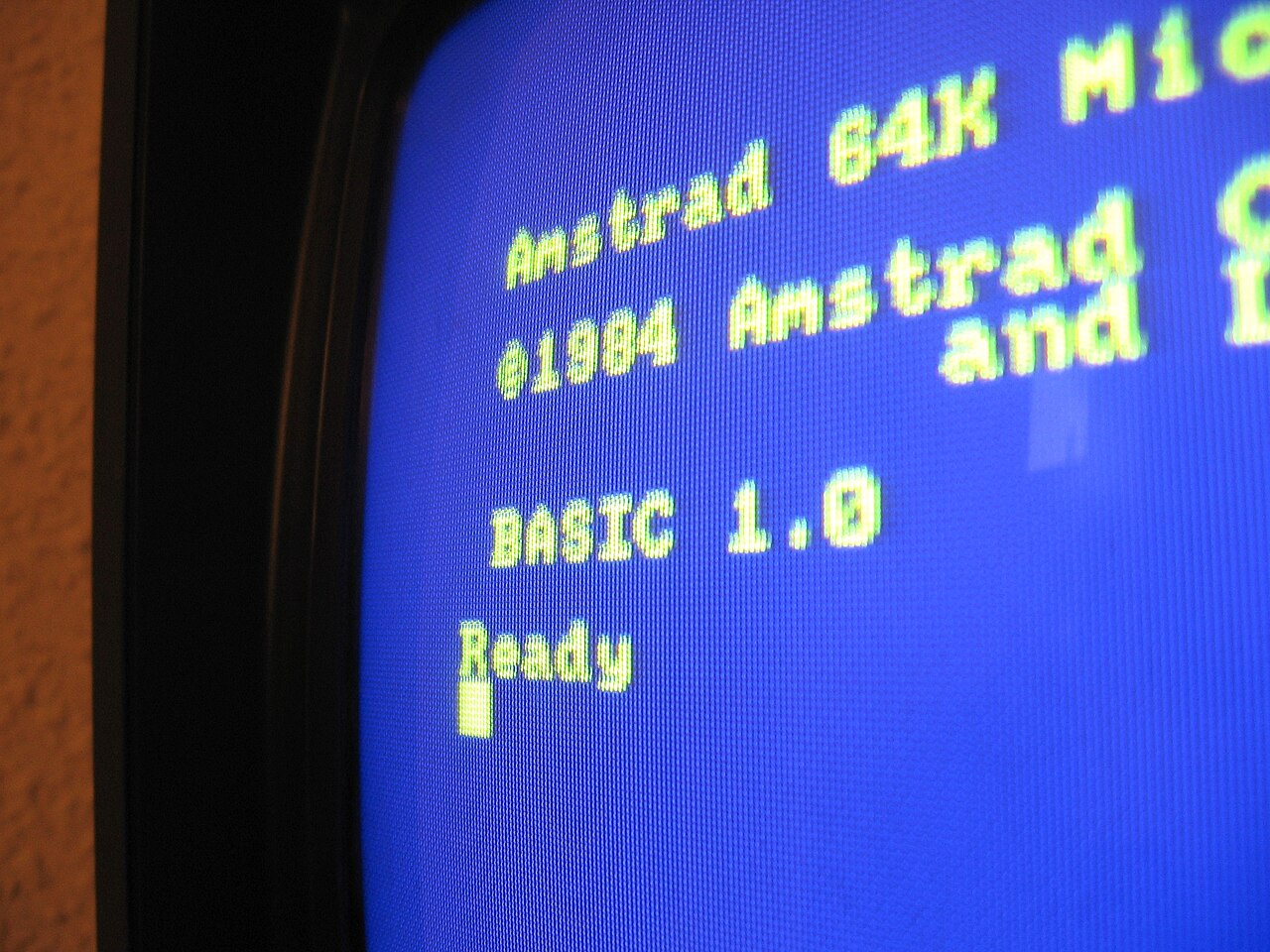 Close-up of an Amstrad CPC screen showing the yellow-on-blue Locomotive BASIC start-up text