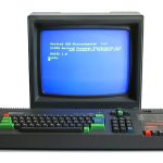 The Amstrad CPC 464: a black keyboard unit with red, green and blue keys and a cassette deck built in on the right